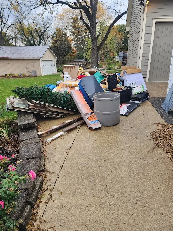 Dumpster being loaded with debris for 12 Yard Dumpster Rental in Narberth